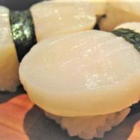 Hotate Nigiri · Raw, Sweet, Giant Sea scallop with tobiko, ginger & Yuzu Ponzu.  2 pcs