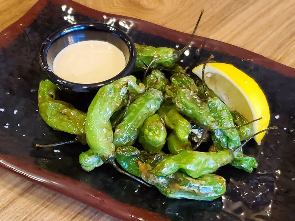 Shishito Peppers · Japanese snacking peppers - mostly mild but some are spicy! Served with our House White Sauce and a slice of lemon.