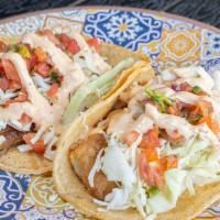 Grilled Fish Taco · grilled fish topped with tartar, cabbage and salsa