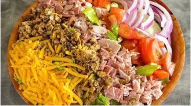 Chef Salad · Fresh cut iceberg lettuce with chopped ham, salami, chicken, tomatoes, red onions, cheddar cheese and choice of dressing.