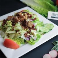 Brickyard House Salad · Romaine, iceberg, cucumber, red onion, tomato, croutons, bacon & chopped egg served in a red...