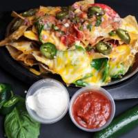 Cheesy Nachos · Corn tortilla chips, melted cheese, pico the gallo, sour cream, salsa and jalapenos.