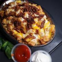 Cheesy Tater Tots · Fried tater tots topped with melted cheese. Bacon optional.