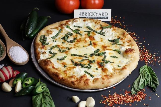 Quattro Formaggio Pizza · White pizza with fresh & dry mozzarella, ricotta & Romano cheeses topped with basil