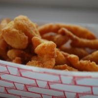 Clams & Chips · Breaded and deep-fried clam strips with tartar sauce and a side of fries.