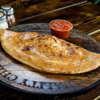 Ricotta and Mozzarella Calzone · The simplicity of mozzarella and ricotta in our wood fired dough served with our homemade ma...