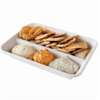 Spread Trio · Crispy Pita Chips with your choice of three spreads: Hummus, Spicy Red Pepper Harissa Hummus...