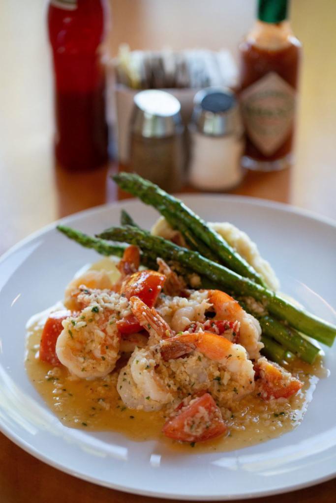 Shrimp Scampi · This dish is fantastic! It is sautéed prawns with tomatoes, garlic butter sauce, grilled asparagus and choice of pasta or mashed potatoes.
