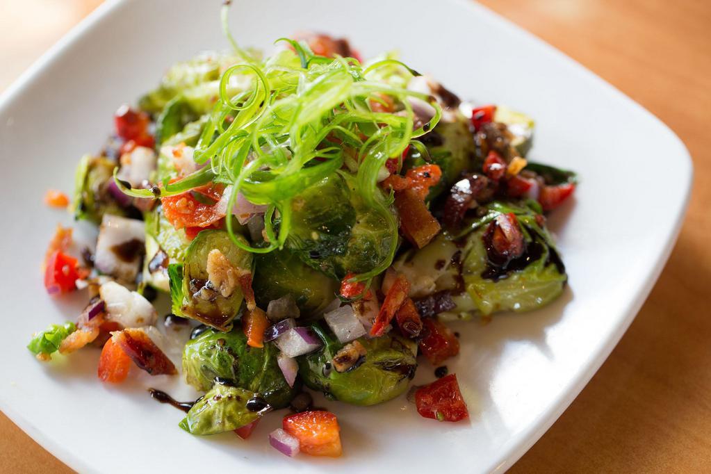 Roasted Brussels Sprouts · A mix of red peppers, onions, bacon and Brussels sprouts, sautéed to crisp bites, topped with balsamic glaze and julienned green onions.