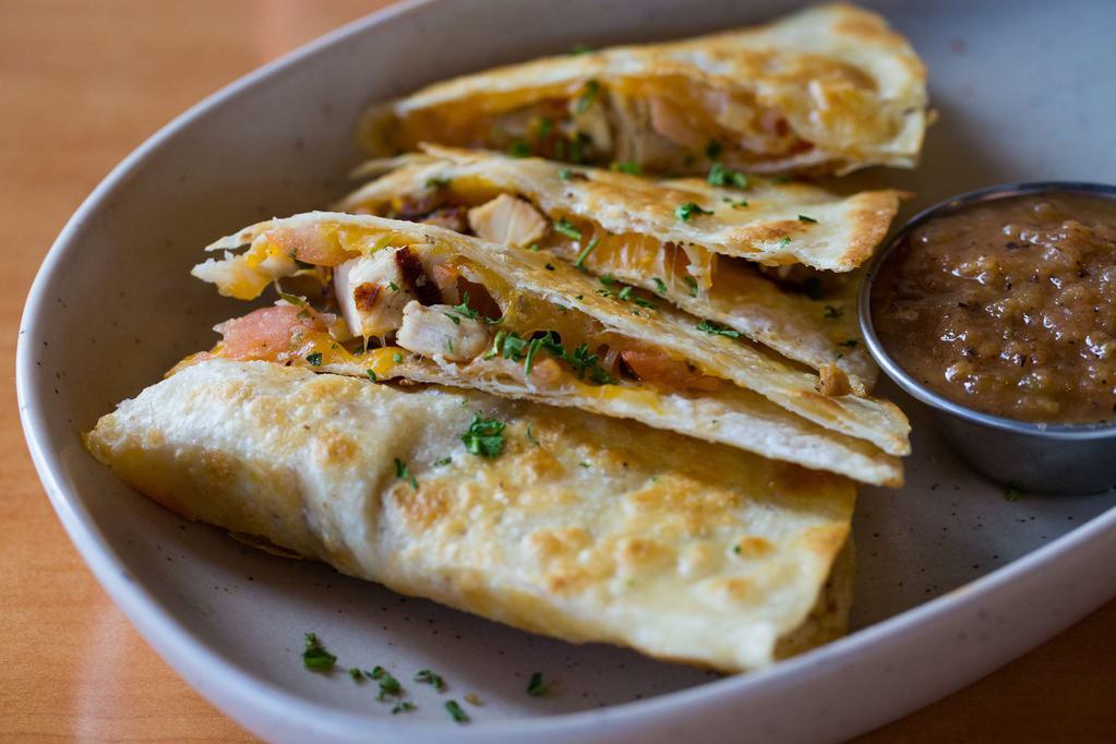 Chicken Quesadilla · This is an authentic quesadilla with tender pieces of chicken lightly seasoned, with pico de gallo and lime sour cream, served with roasted salsa.