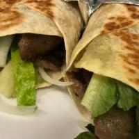 Beef Gyro · Thin slices of seasoned beef, cooked on flat grill and served on warm pita bread filled with...