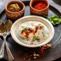 Dahi Vada · Lentil donuts served dipped in fresh yogurt with dates chutney sprinkled on it. 