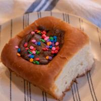 Cosmic Brownie Kolache · Ooey gooey triple chocolate brownie filling inside our kolache dough and topped with candy s...