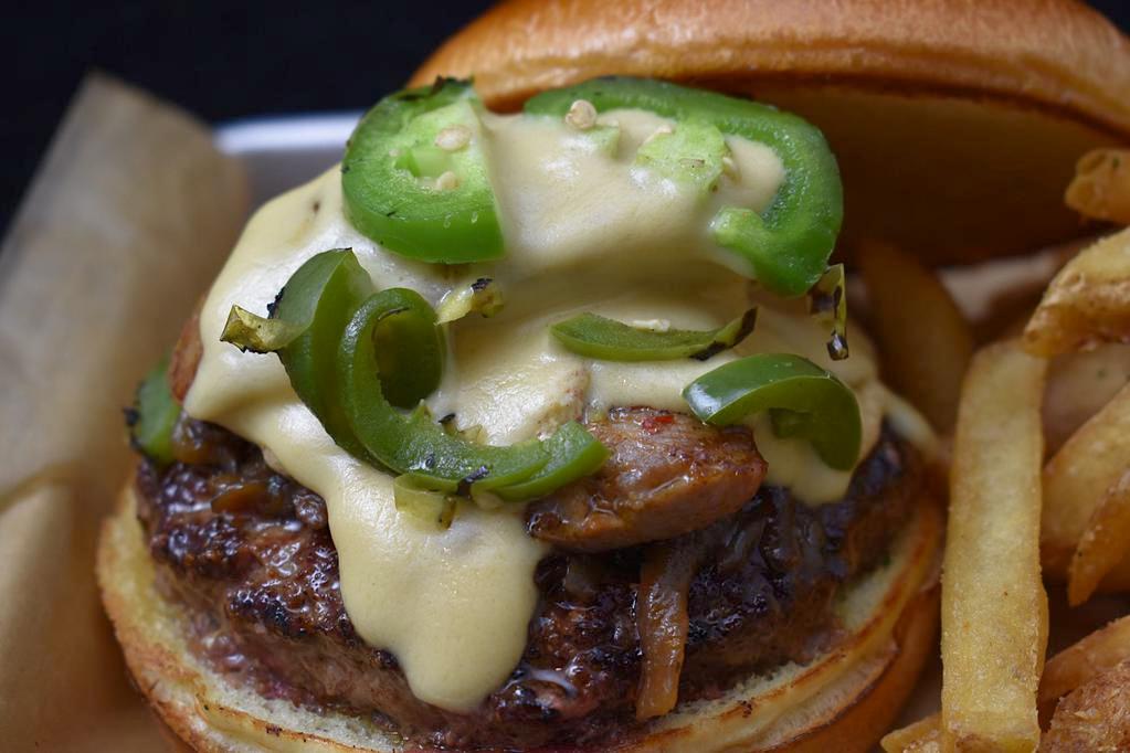 The Combine Burger · Beef patty, pastrami, caramelized onion, charred  jalapeno, peeper jack cheese, avenger IPA mustard. Served on a butter grilled bun with jalapeno aioli.