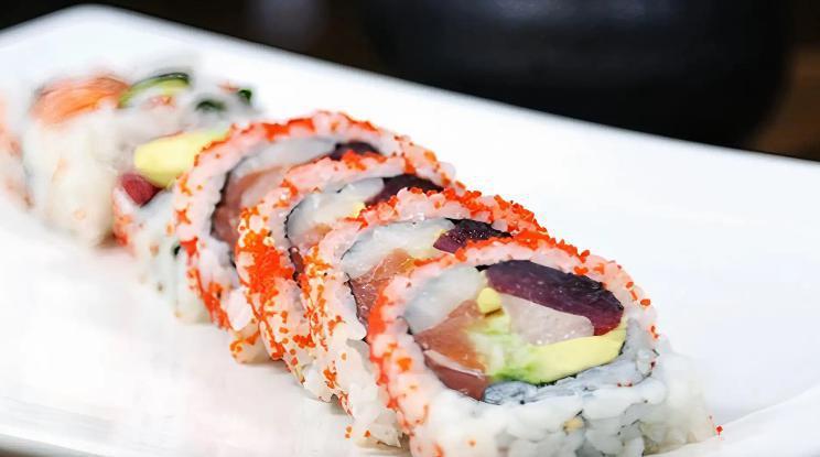 R46. Chef's Special Roll · Tuna, salmon, yellowtail, white fish, avocado, cucumber with tobiko outside.