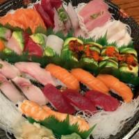D10. Love Boat · 12 pieces sushi and 15 pieces sashimi, 1 rainbow roll and 1 dragon roll.