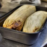 Tamales (2) · corn tamale topped with choice of sauce, sour cream, and cheese