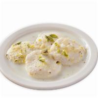 Ras Malai (4 Pieces) · Small balls of curd cheese (Paneer) served in a cold thick and sweetened milk sauce.