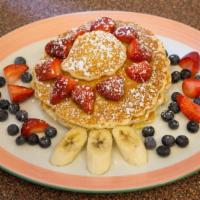 Multigrain Pancakes · Topped with Greek yogurt and assorted berries.