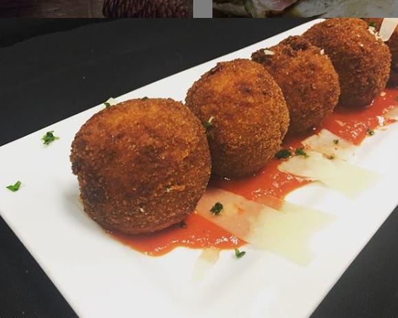 Arancini · Fried risotto and pepper jack cheese balls served with a roasted red pepper sauce.