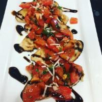 Brasserie Bruschetta · Toasted bread with tomatoes, basil, onion, and garlic topped with asiago, drizzled with oliv...