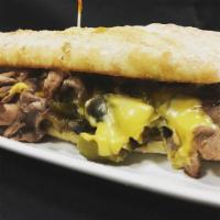 Philly Cheese Steak Sandwich · Shaved steak, sautéed peppers, onions, mushrooms, and American cheese on a toasted baguette.