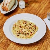 Bucatini alla Carbonara · Rome. Thick spaghetti served with pancetta, pecorino, Parmigiano, black pepper and finish wi...
