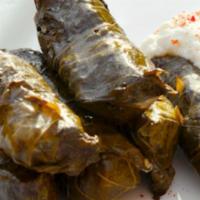 Yalanci Dolma · Freshly prepared grape leaves stuffed with rice, currants and pine nuts. Served with Pita br...