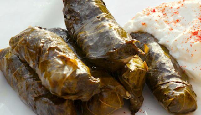 Yalanci Dolma · Freshly prepared grape leaves stuffed with rice, currants and pine nuts. Served with Pita bread.