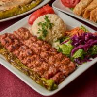 Chicken Adana Kebab · Char grilled spicy ground chicken seasoned with Turkish spices and served over rice and sala...