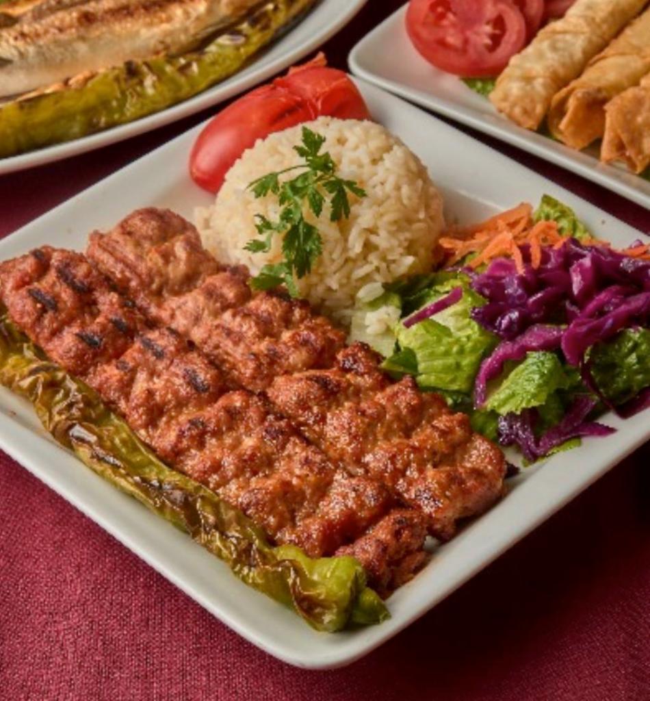 Chicken Adana Kebab · Char grilled spicy ground chicken seasoned with Turkish spices and served over rice and salad. 