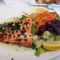 Grilled Atlantic Salmon · Char grilled salmon fillet served with salad and chef's special sauce. 