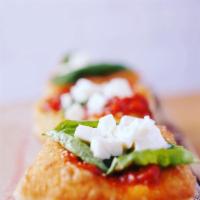Montanara · Fried pizza dough smothered in tomato sauce, mozzarella cheese, and parmesan cheese. Three p...