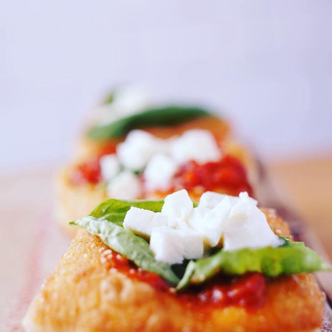 Montanara · Fried pizza dough smothered in tomato sauce, mozzarella cheese, and parmesan cheese. Three pieces.