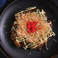 Okonomiyaki · Japanese pancake with seafood and vegetables.