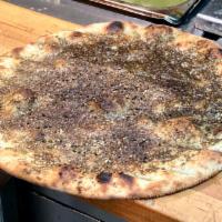 Zaater Bread · Pita topped with olive oil, sesame and thyme. Served with lemon juice and olive oil mixed in...