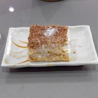 Napoleon Cake · Layered puff pastry cake with homemade whipped cream and powdered sugar.