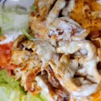 Arroz con Pollo · Tender sliced grilled chicken breast on a bed of Spanish rice topped with nacho cheese. Serv...