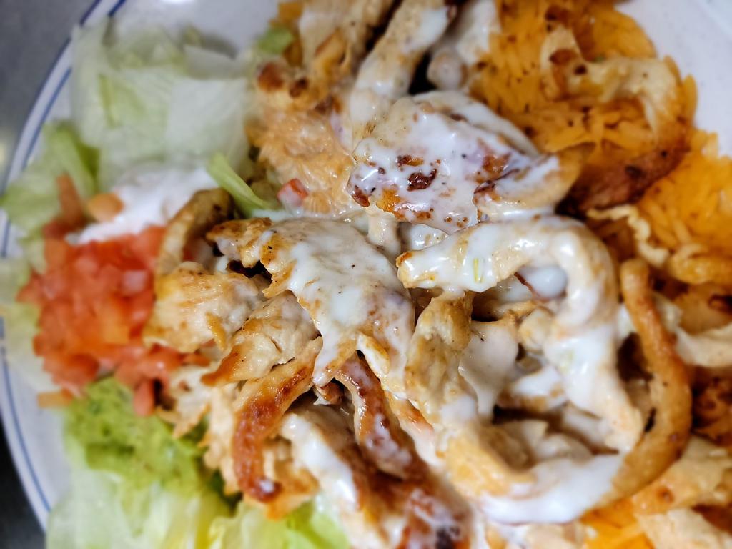 Arroz con Pollo · Tender sliced grilled chicken breast on a bed of Spanish rice topped with nacho cheese. Served with guacamole salad and sour cream. 