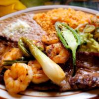 Carne Asada Con Camaron · Grilled thin sliced steak and shrimp served with rice, beans, guacamole salad, pico de gallo...
