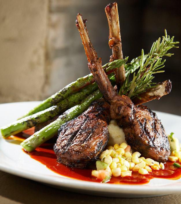 Rack of Lamb · Herb & Chile grilled rack of lamb over Yukon Gold mashed potatoes with a New Mexico Red Chile Sauce, Grilled Asparagus, & a Citrus Corn Relish