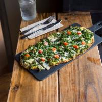 Kale Parmesan Flatbread · Cherry tomatoes, red onions and basil pesto.