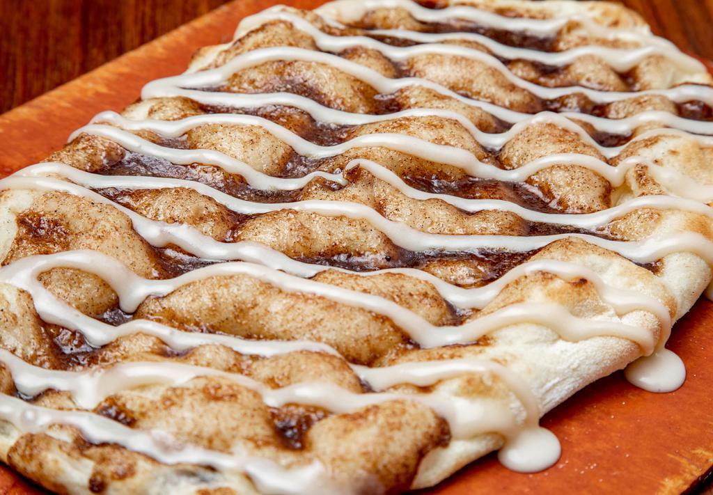CINNAPINSA* · Cinnamon butter topped Pinsa base, drizzled with a vanilla cream cheese icing.