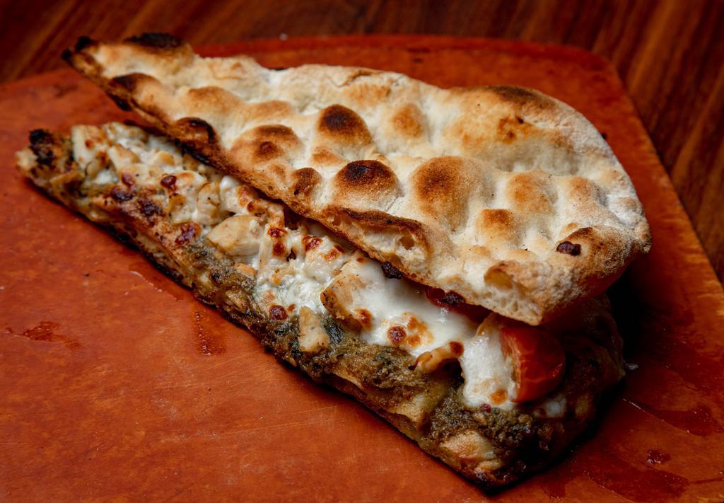 CHICKEN PESTO SANDWICH* · Pinsa bread base, housemade pesto, chicken, mozzarella cheese, tomatoes and fresh basil.