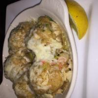 Baked Stuffed  Mushroom Caps · Our signature seafood stuffing baked in garlic butter and topped with Asiago cheese.