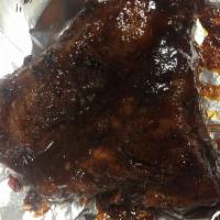 Jerk BBQ Baby Back Ribs · 1/3 rack of baby  back ribs smothered and caramelized in spicy jerk BBQ sauce.
