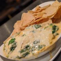 Creamed Spinach Dip · Sauteed spinach and artichoke hearts in a creamy cheese sauce, served with corn tortilla chi...