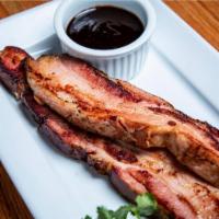Hickory-Smoked Bacon · Thick-sliced, house-cured & smoked, served with our house-made steak sauce.