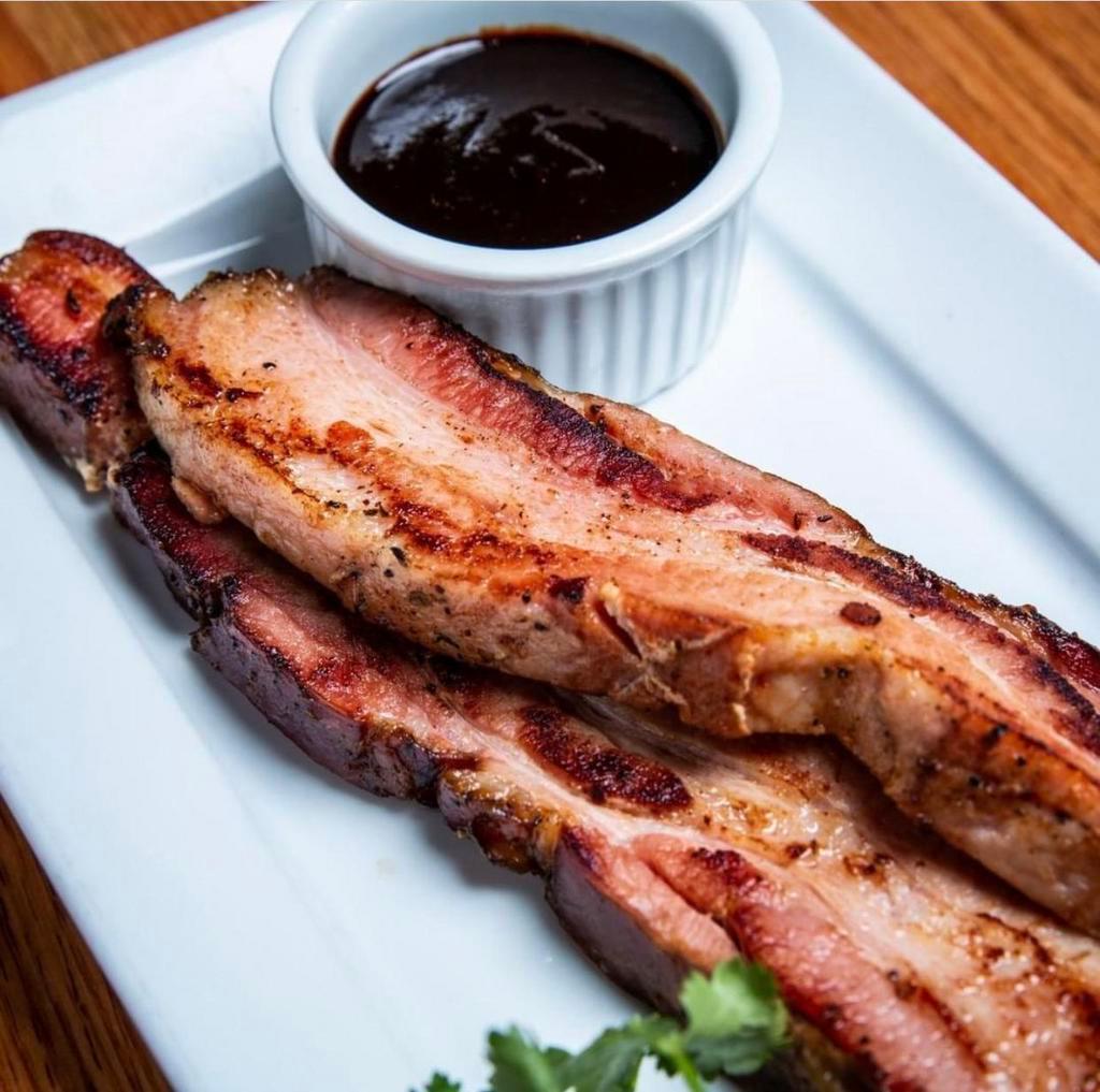 Hickory-Smoked Bacon · Thick-sliced, house-cured & smoked, served with our house-made steak sauce.
