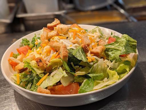 House Salad · Iceberg, romaine, shredded carrots topped with tomato wedges, croutons and shredded cheddar cheese.